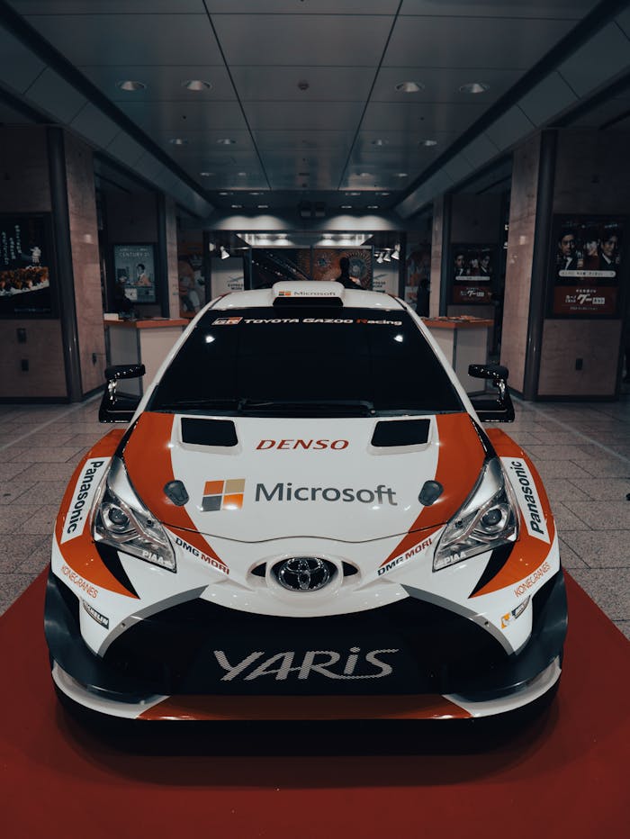 Home Front view of a Toyota Yaris rally car on display, showcasing motorsport branding.