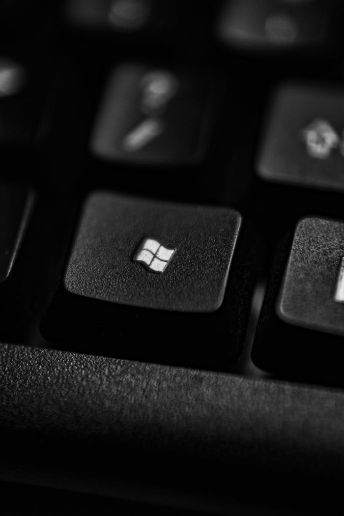 Home High-quality close-up of a Windows logo key on a black plastic keyboard.